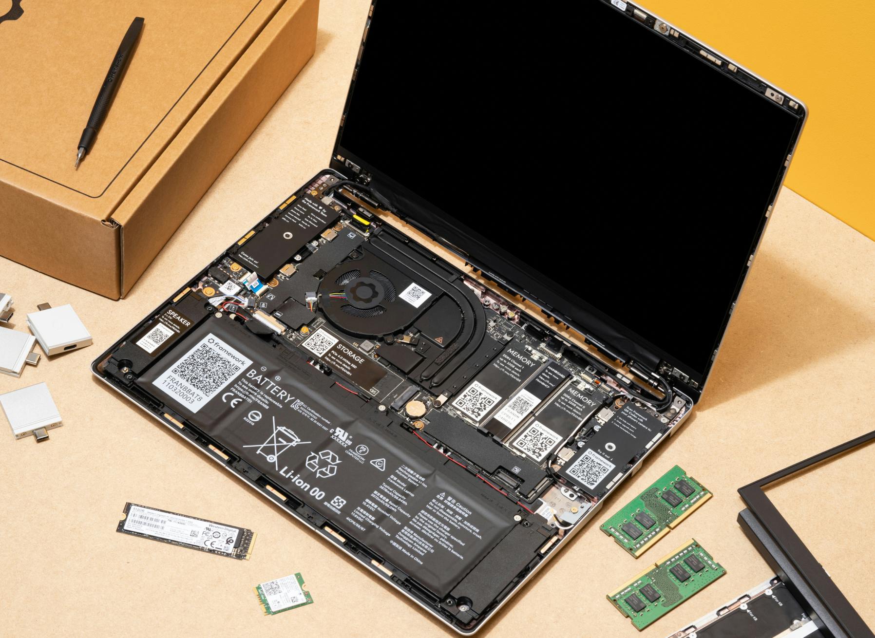 Framework Laptop with parts and packaging around