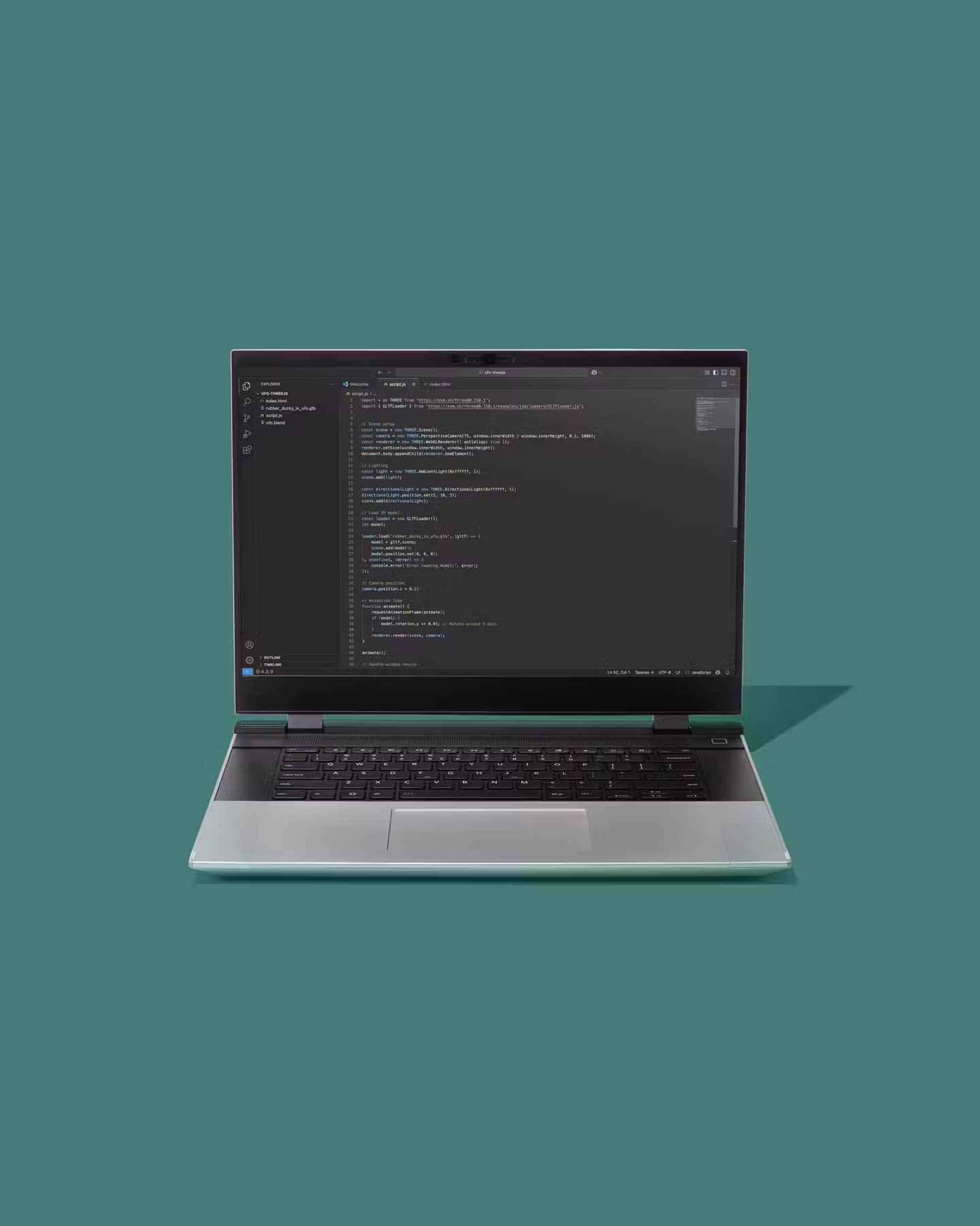 Straight-on studio shot of a Framework Laptop with code on screen placed against a teal backdrop.