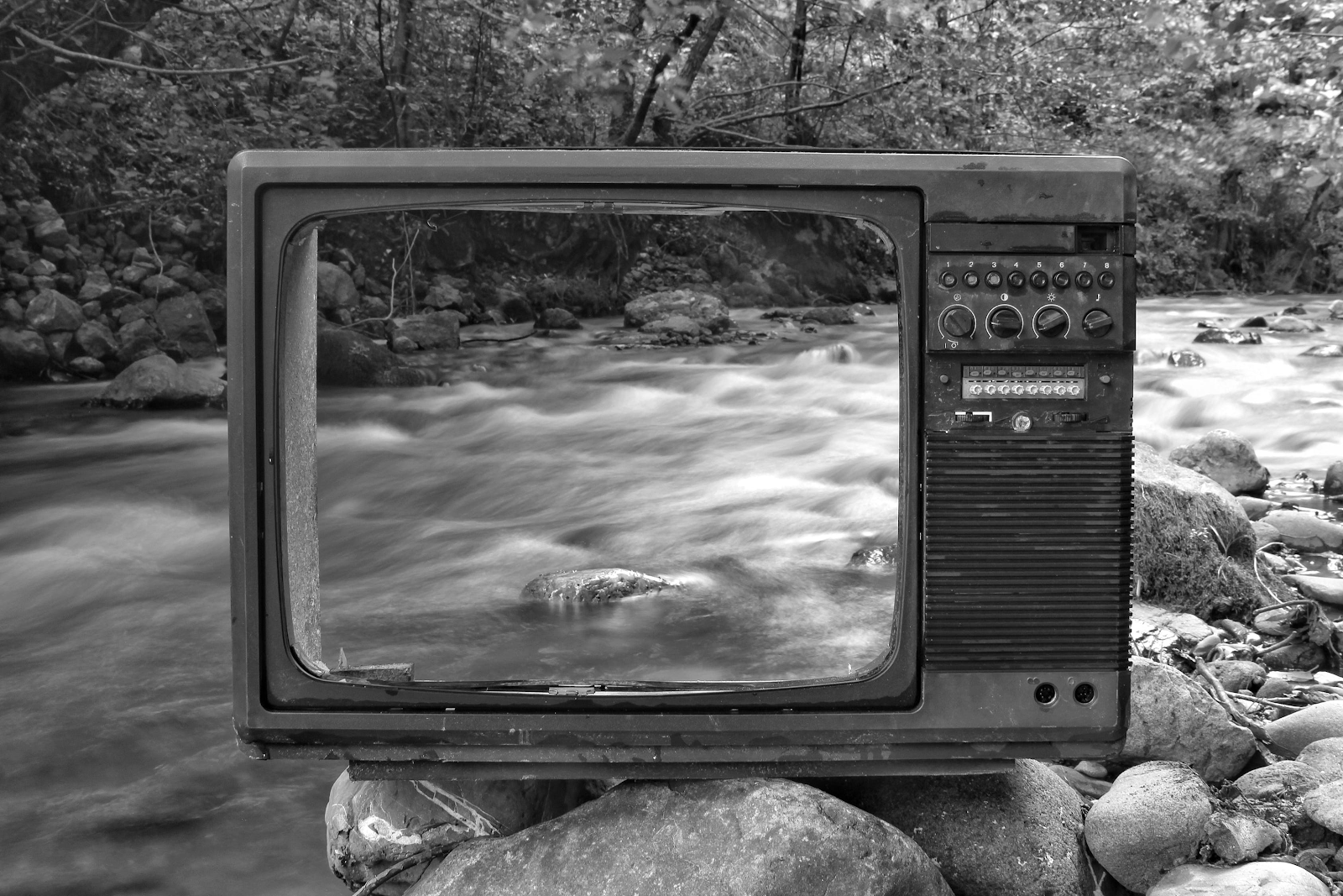 An empty TV screen in front of a creek