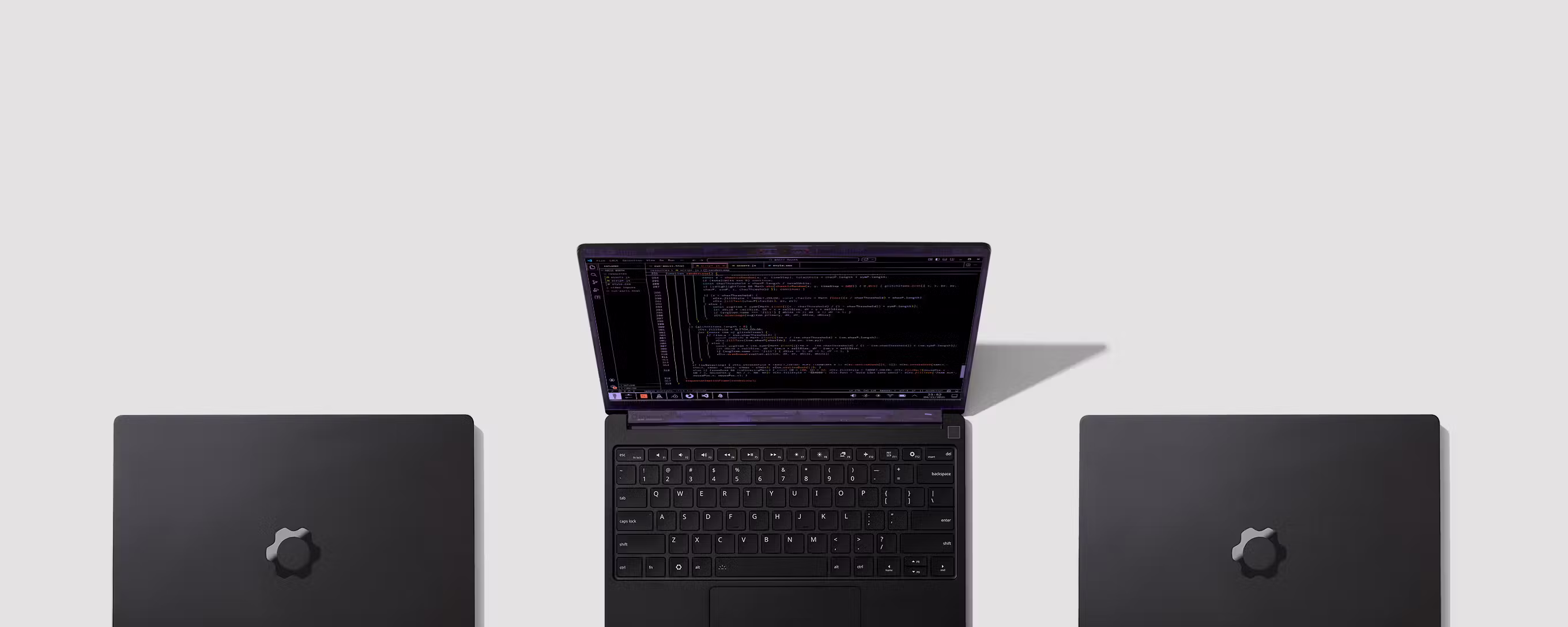 A top-down shot of three Laptop 13 Pros, one opened and the others closed. 