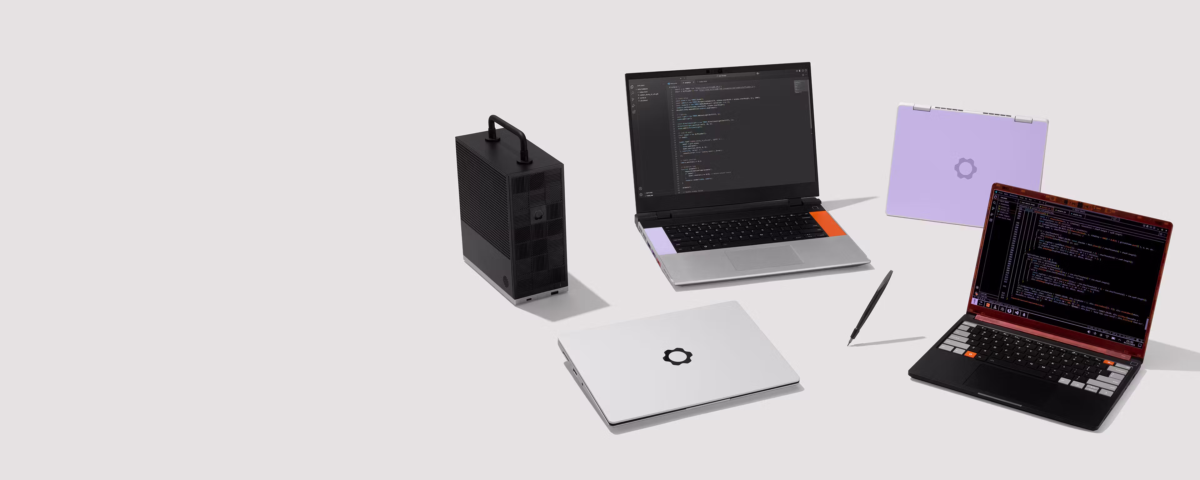 A studio shot of Framework family products: Framework Laptop 16, Framework Laptop 13, Framework Laptop 13 Pro, Framework Laptop 12, Framework Desktop and a FRamework Screwdriver.