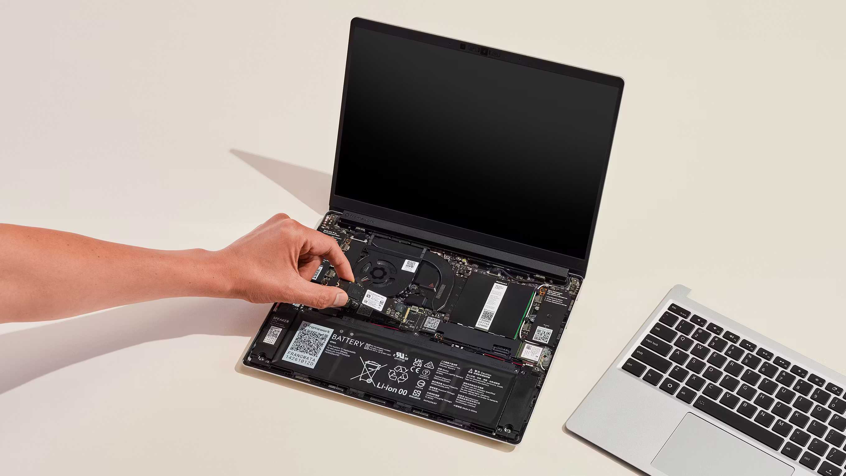 A studio shot of Framework Laptop 13 showing storage installtion.