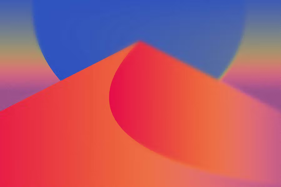 A soft-focus, grainy gradient wallpaper featuring a stylized desert dune in vibrant orange and red. A large, blurry blue circular shape—reminiscent of a sun or moon—rises behind the dune against a colorful twilight sky.