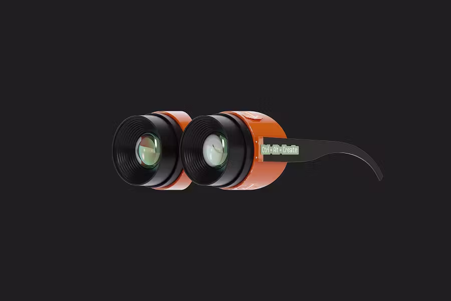 A high-contrast wallpaper on a dark grey background featuring a pair of futuristic orange goggles or binoculars. The side arm of the goggles has a small green label that reads "Ctrl + Alt + Create."